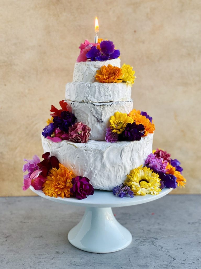 cheese wheel wedding cake edible flowers