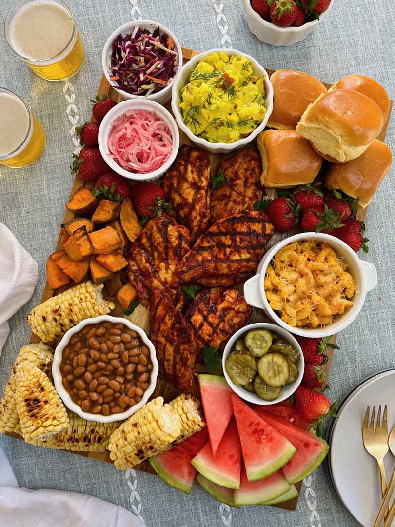 Delicious spread of Memorial Day recipes featuring grilled meats, vibrant side dishes, and red, white, and blue desserts.